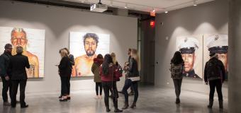 people gathered in gallery looking at paintings