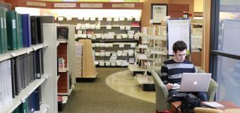 student working on laptop in lesley university bookstore
