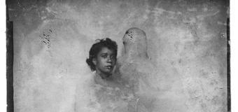 black and white photo of two people blurred out except for a woman's head