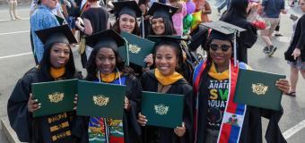 Six Lesley masters graduates in caps and gowns 