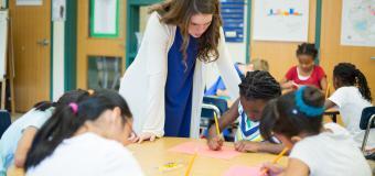 teacher at a table with students