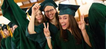 Graduates smile for the camera.