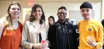 four students pose for a photo at the reception