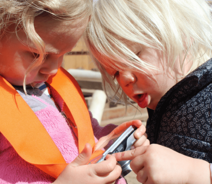 Kids looking at a phone