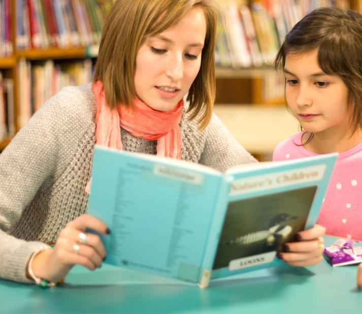 teacher reading to student 