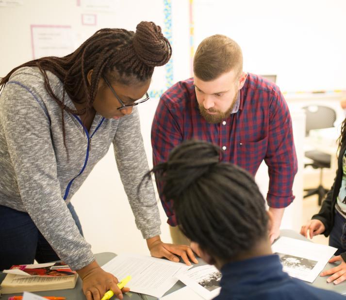teacher with 2 students at a desk 