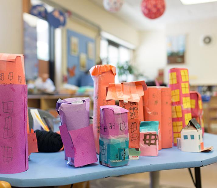 Early childhood classroom with table of colorful handmade paper structures