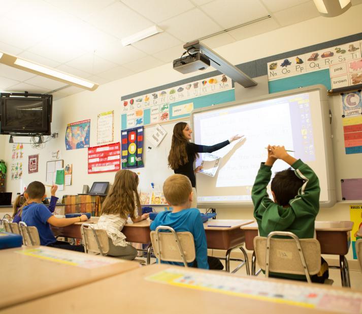 Teacher teaching in front of the classroom