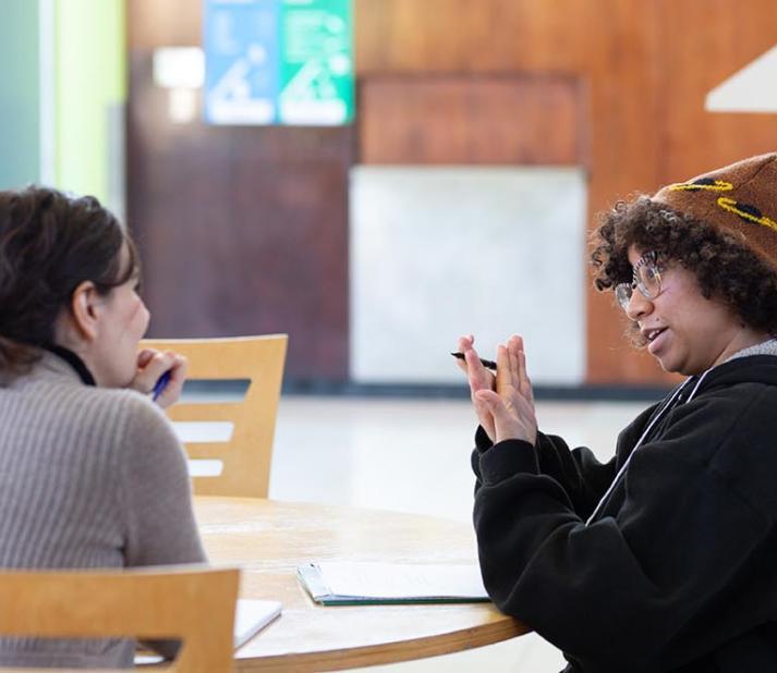 Two female graduate students talking in a counseling class