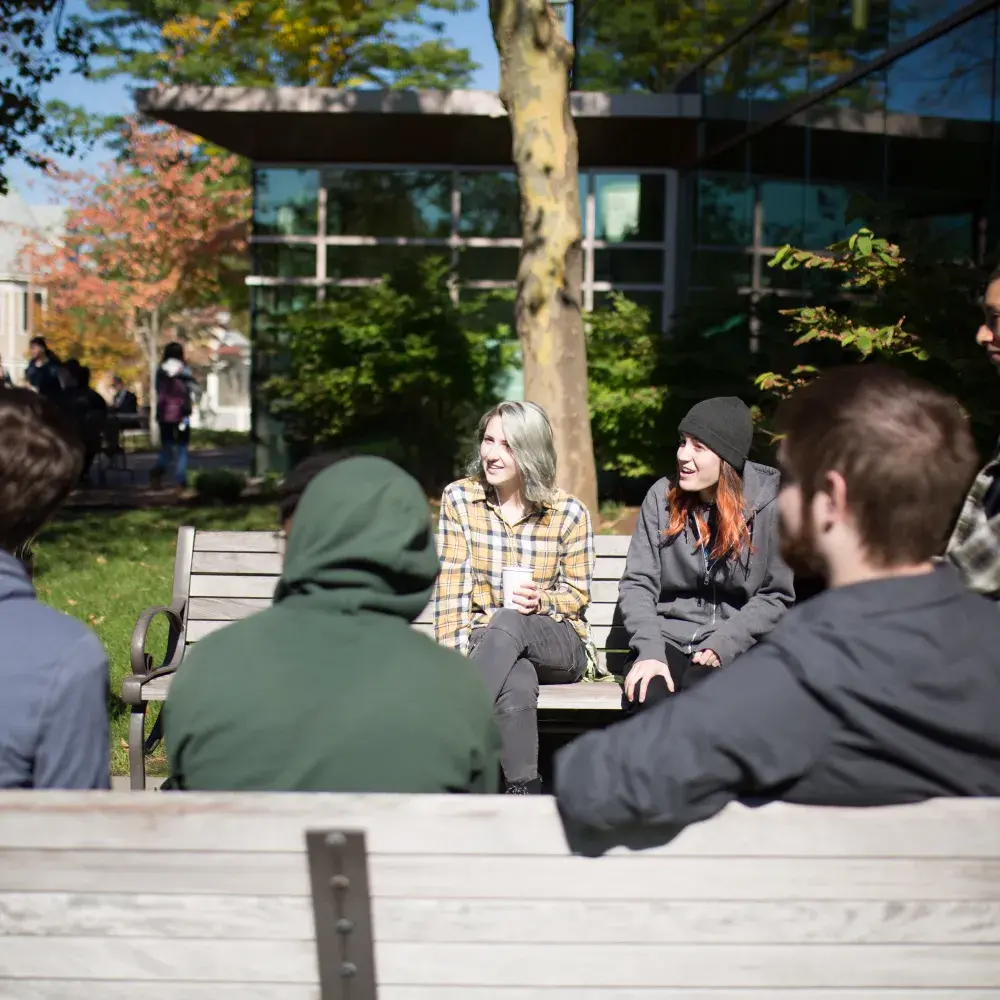 Students drinking coffee outside on the Lesley campus