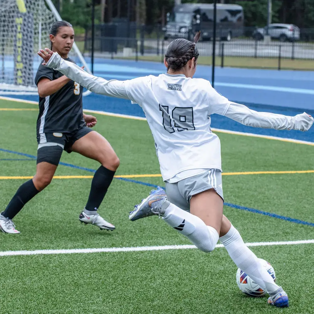 soccer player kicking ball