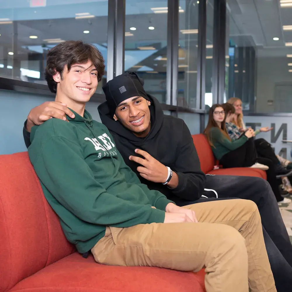 2 guys chilling lounge peace sign