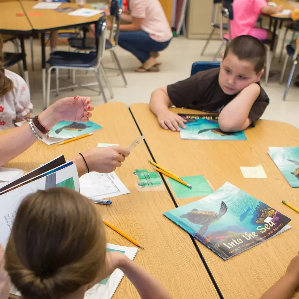 Teacher and students reading books