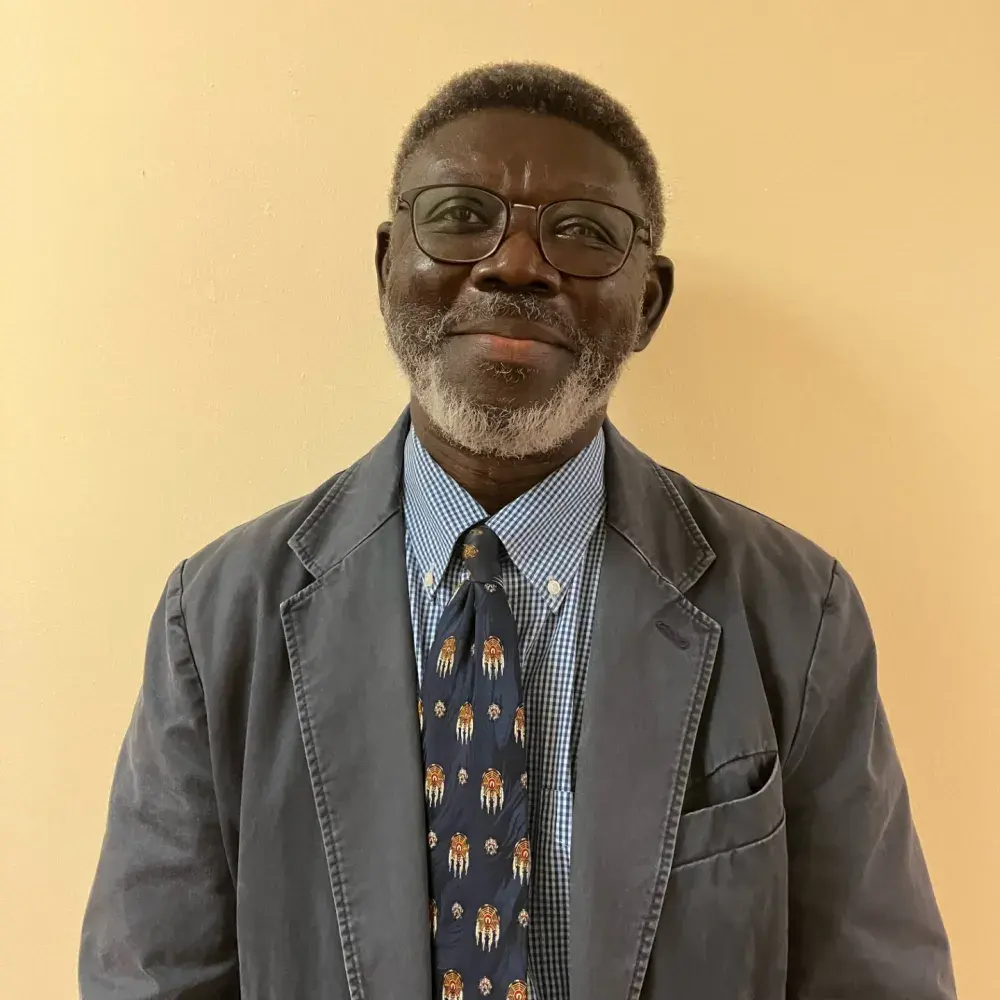 Kabba smiling against yellow background