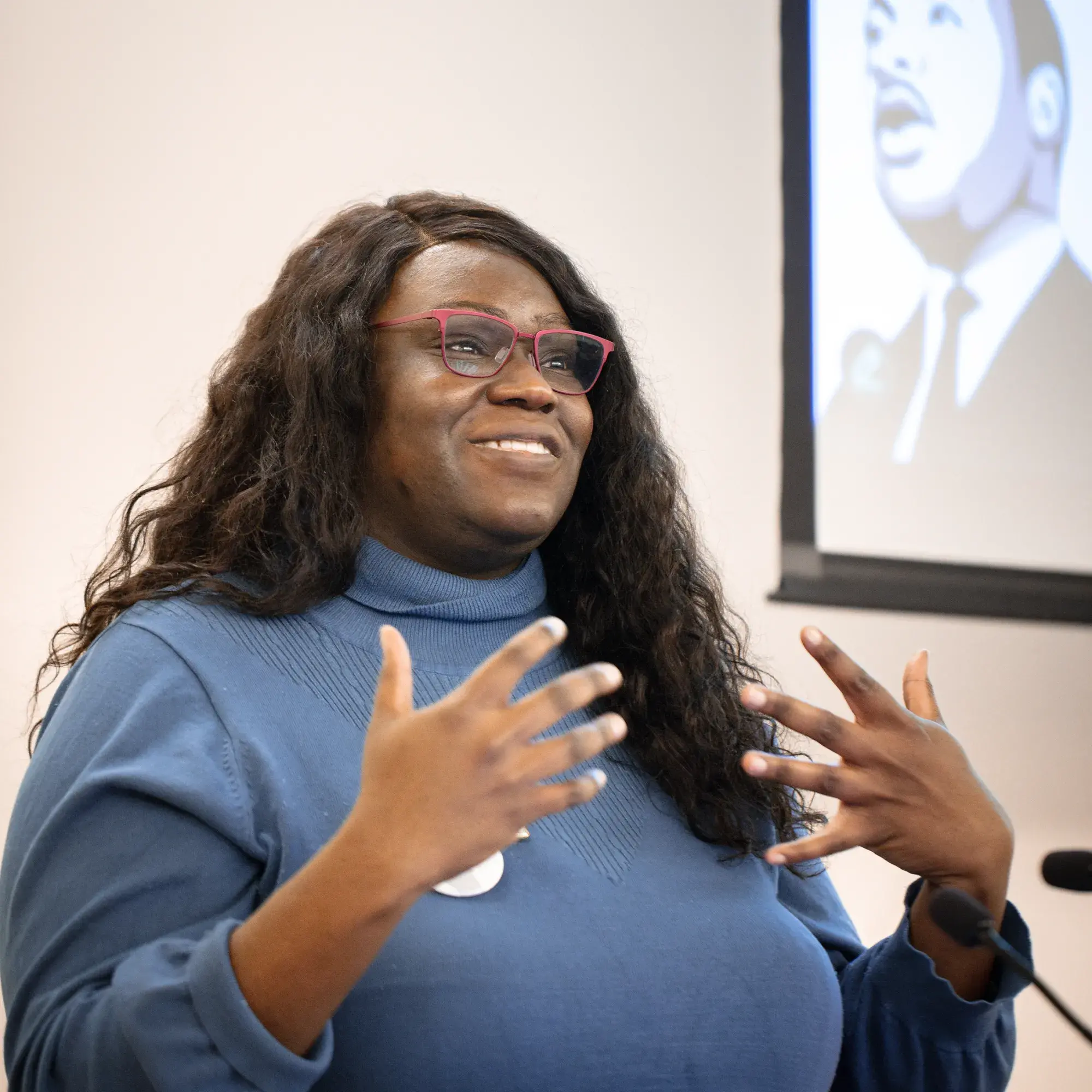 Woman presenting in front of an image of MLK