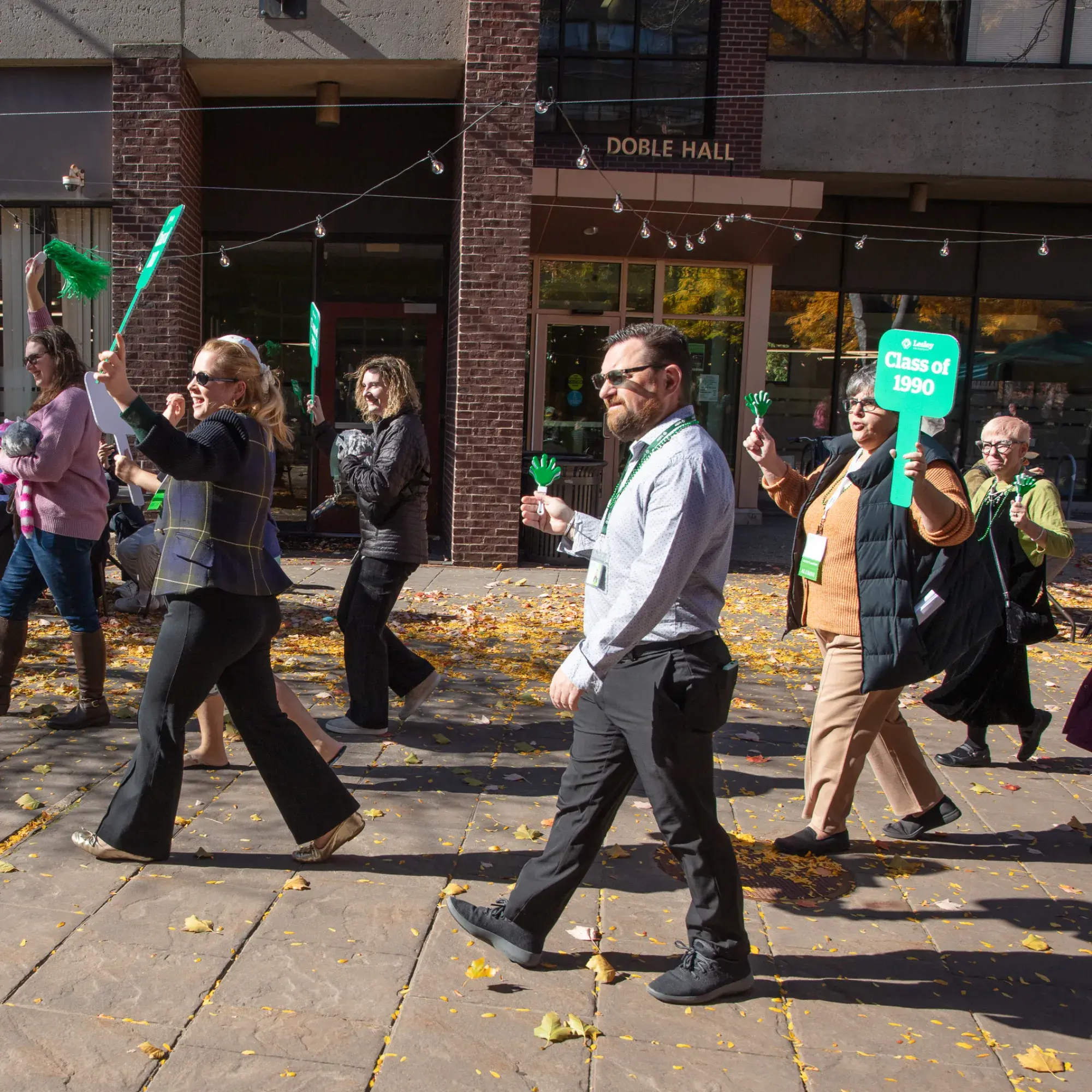 Lesley staff walking through Porter campus with Lesley banners