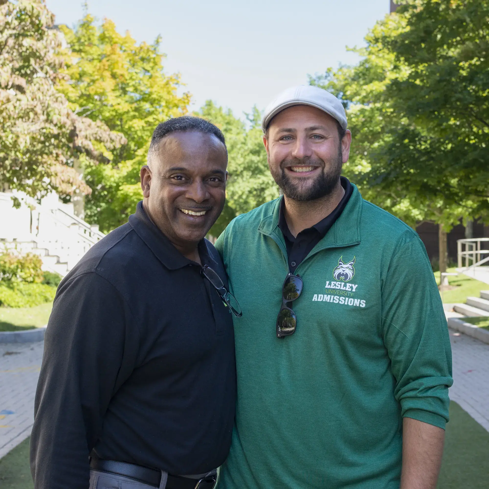 Two people posing outside Lesley in green pull-over jackets
