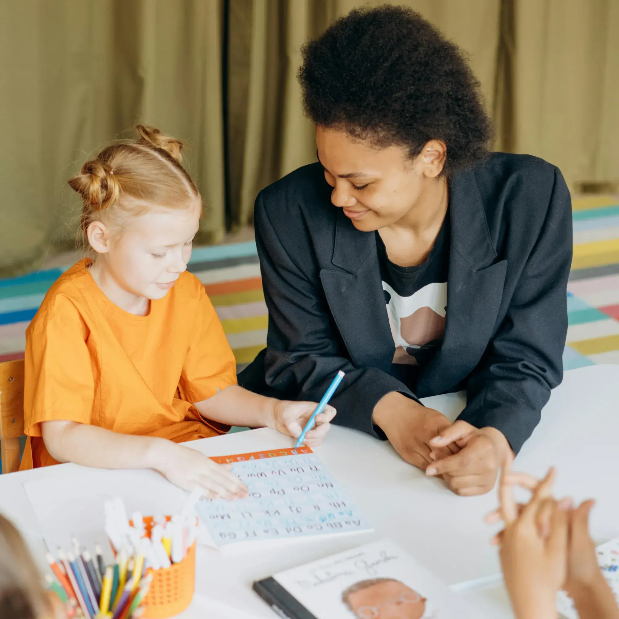 teacher helping student