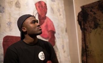 Rocky postulating in front of his artwork