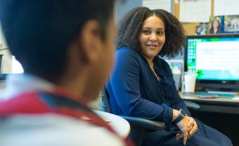 middle school counselor listens to a student in her office