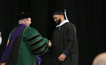 Jesse Sparks receives his diploma from President Jeff Weiss