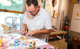 Artist Keith MacLelland working in his studio