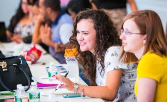 Natalia Rosa and other students sitting at a table in the classroom