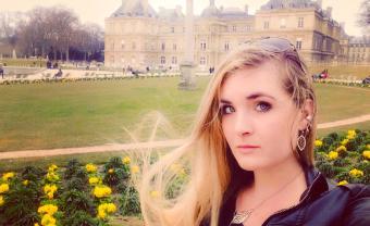 Student Kristina Mccue standing in front of mansion