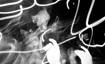 black and white photo of lead singer performing in front row of concert