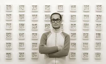 John Chang in front of his artwork