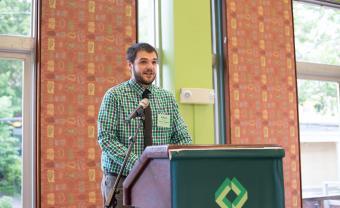 Robert Mitropoulos speaking at a podium during Alumni Weekend.