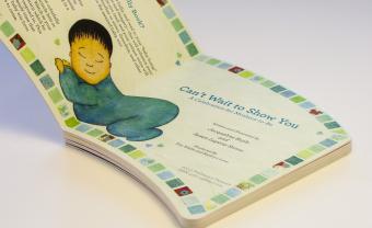 Book open to a page with an illustration of a baby.
