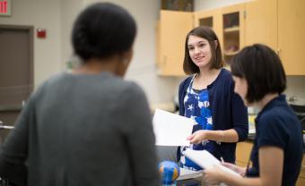 Hannah Willis speaking to her classmates in a lab