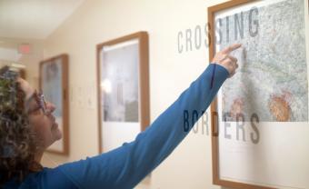 vivian poey pointing at a photograph