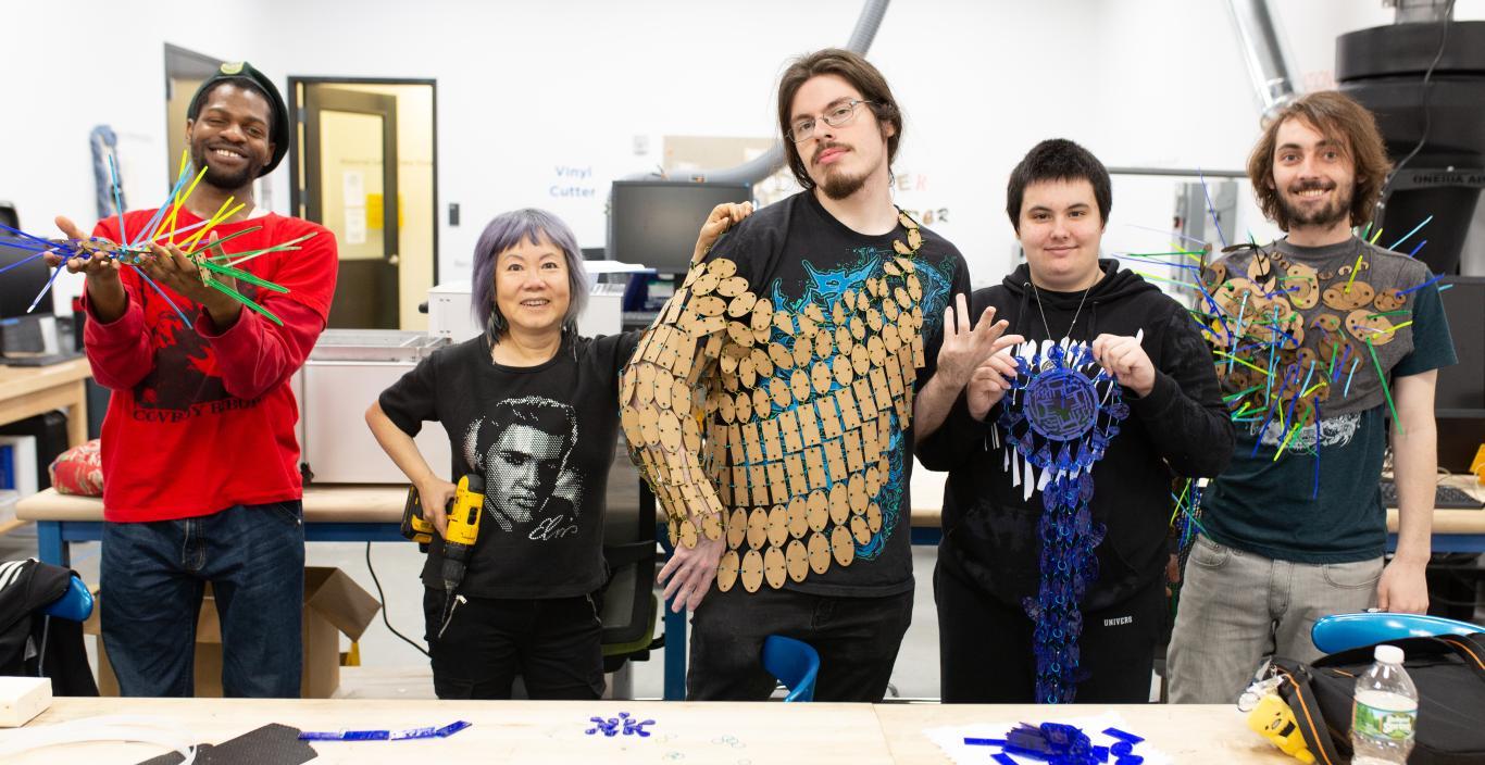 students show off their work in the fabrication studio