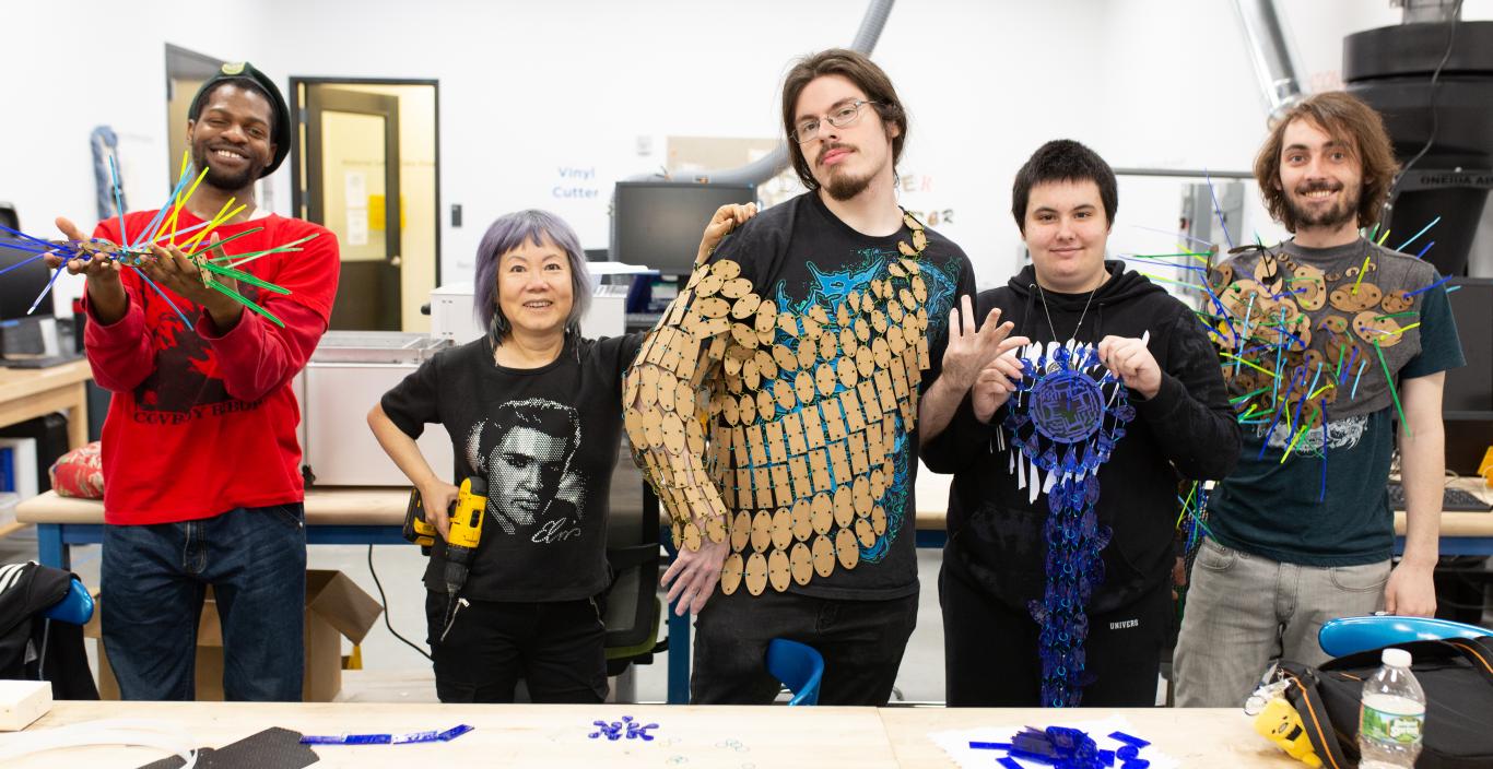 students show off their work in the fabrication studio