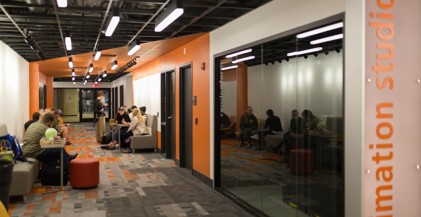 students in the orange animation hallway 