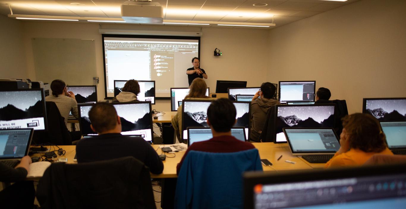 teacher giving a lecture in a computer lab