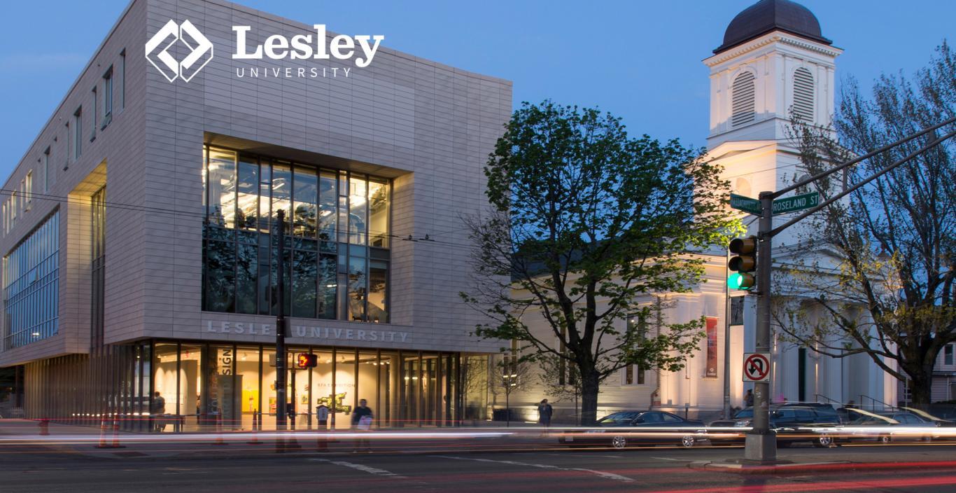 Across the street from Lunder Arts Center at dusk. Streaks of light from passing cars hover above Mass Ave.