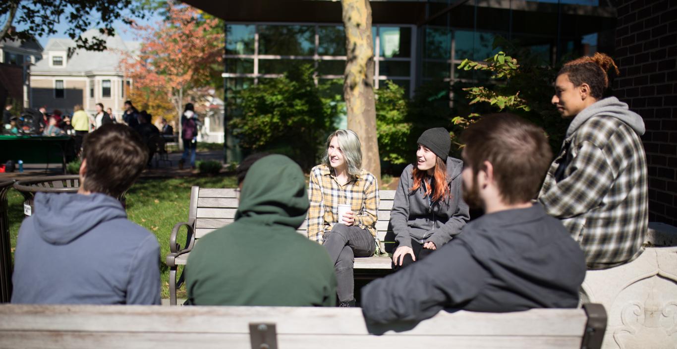 Students drinking coffee outside on the Lesley campus.