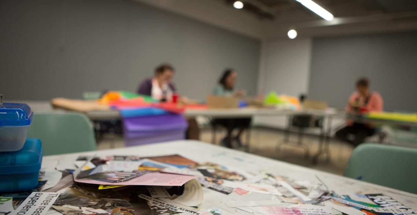Students in a Lesley classroom making art through collage
