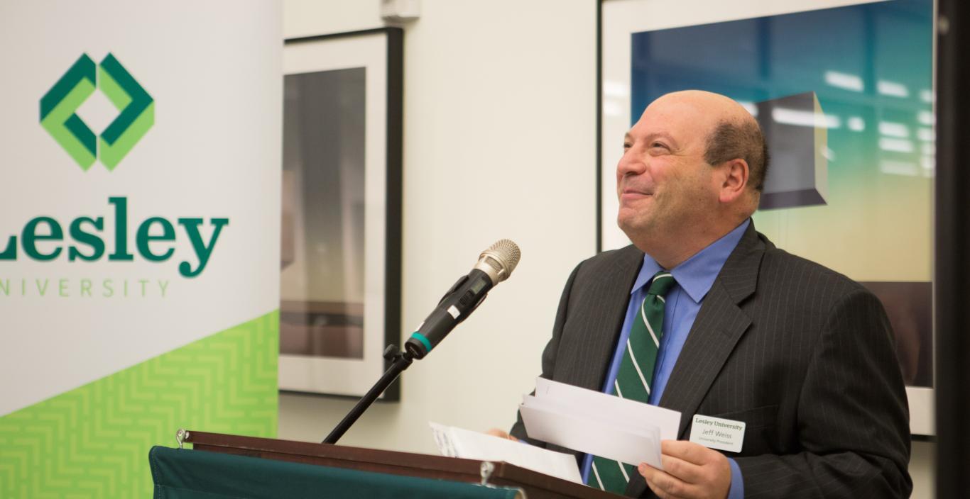 President Jeff Weiss at the podium at Lesley University