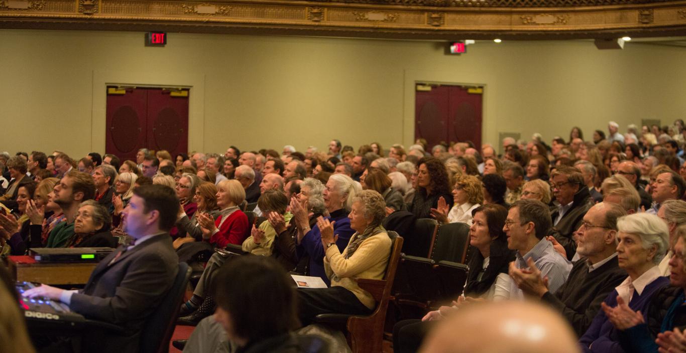 A photo of audience members seated in Symphony Hall for a Boston Speakers Series lecture.