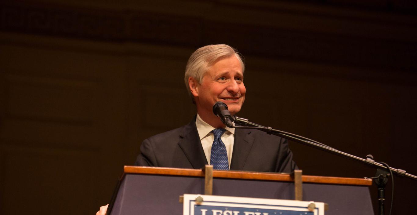 John Meacham speaks at a podium at the Boston Speaker Series.