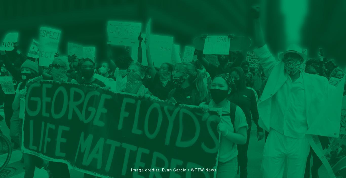 Green filter layered over image of protesters holding various Black Lives Matter-themed signs