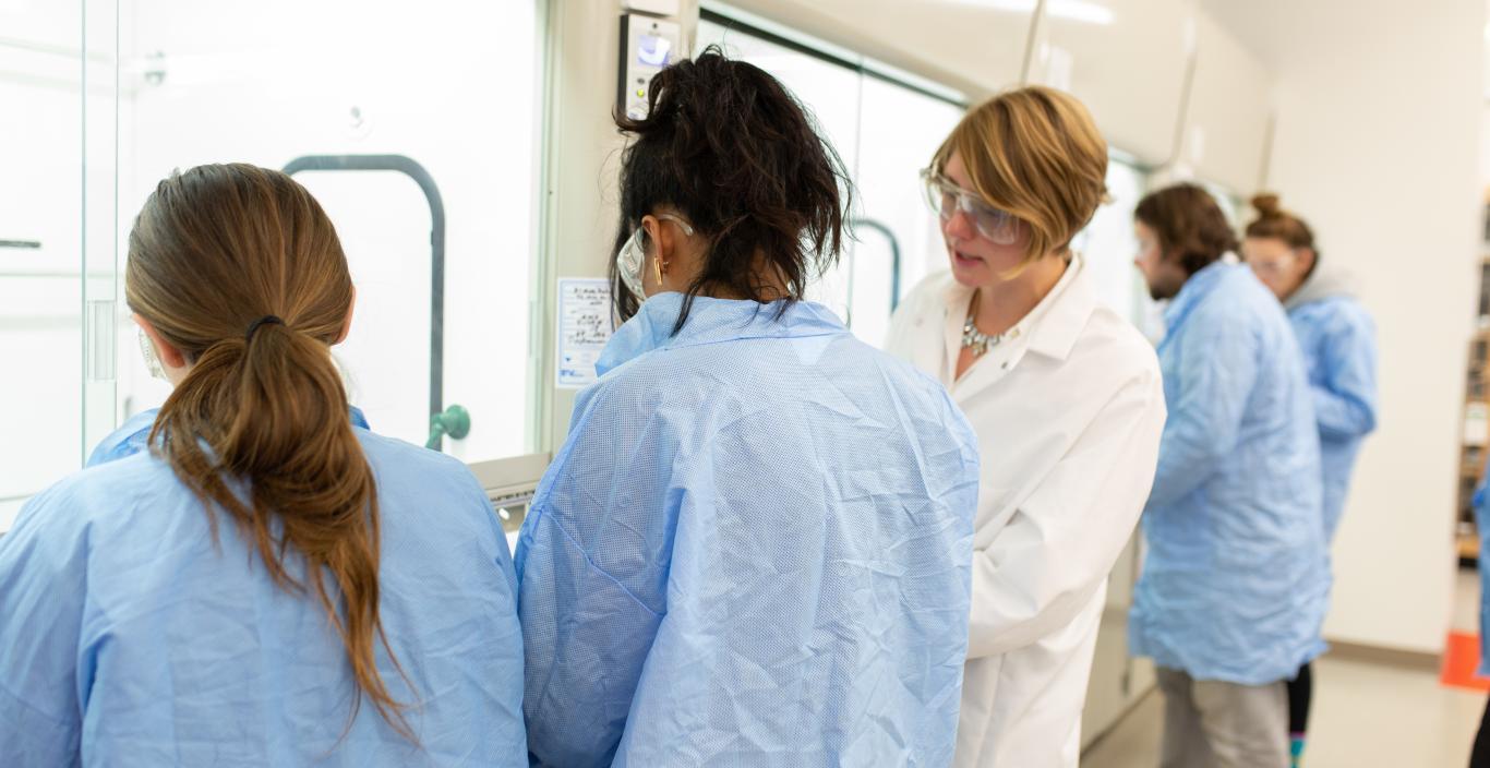 Assistant Professor Grace Ferris and Lesley students in the lab