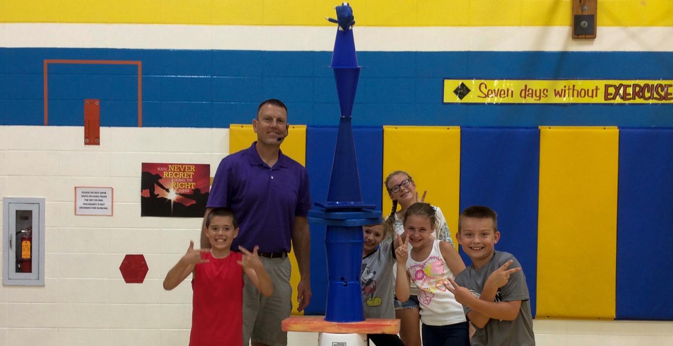 Chris Wendorf with kids in a gym.