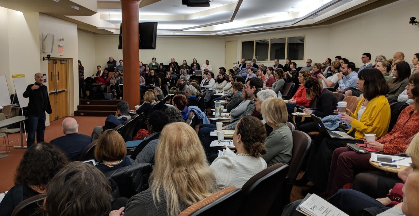 Audience of more than 100 people at University Hall Amphitheater