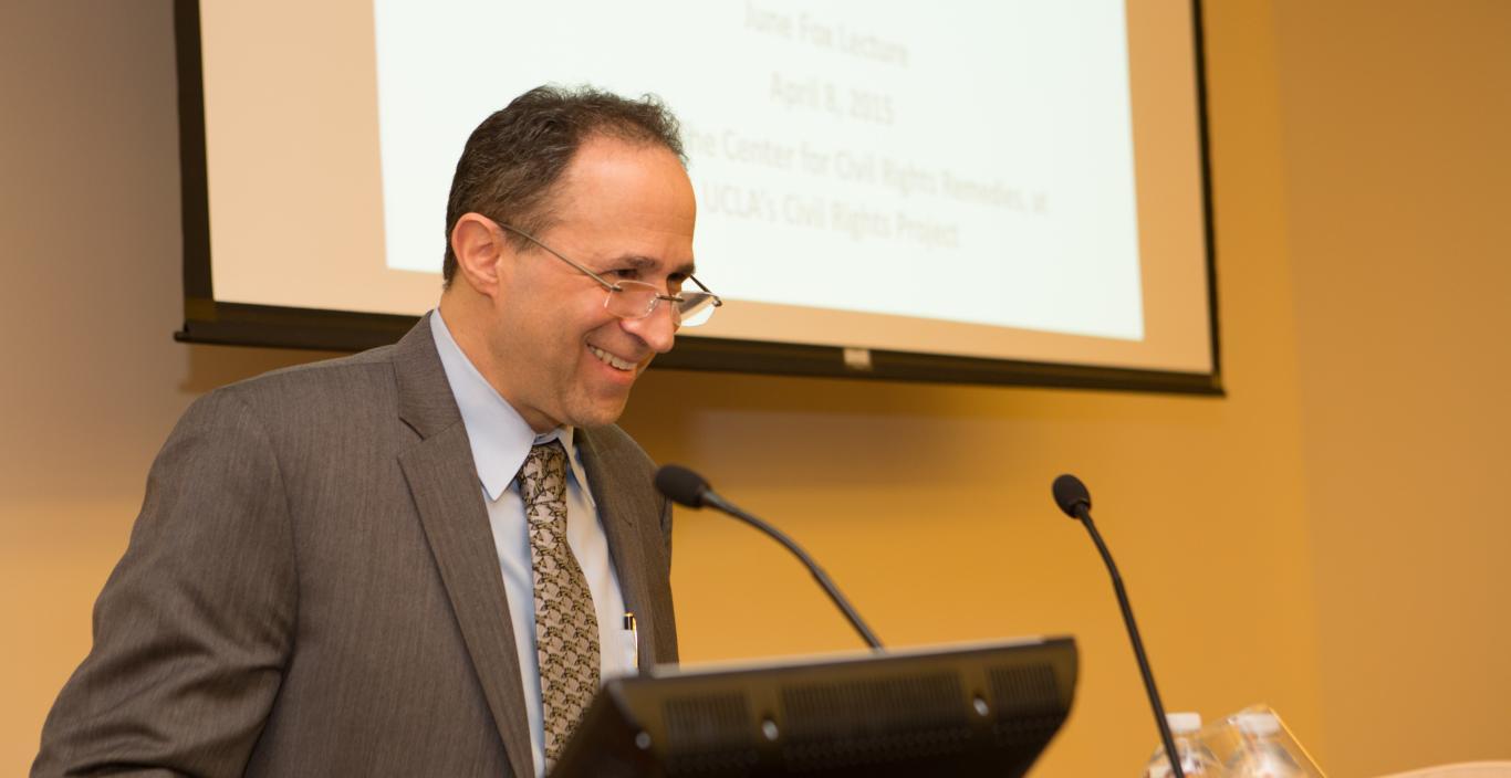 Dan Losen speaking at podium