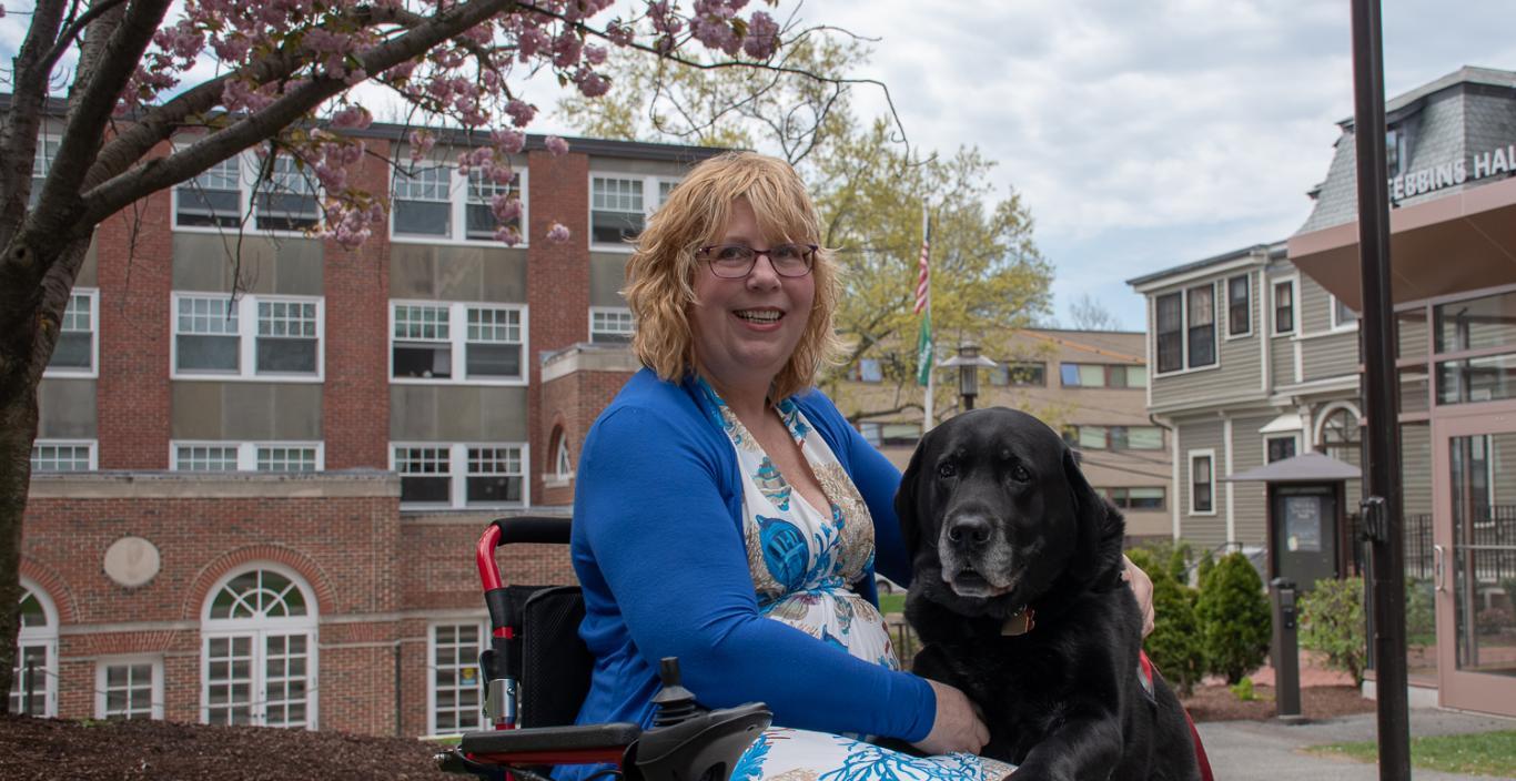 Dee Genetti and her service black lab service dog